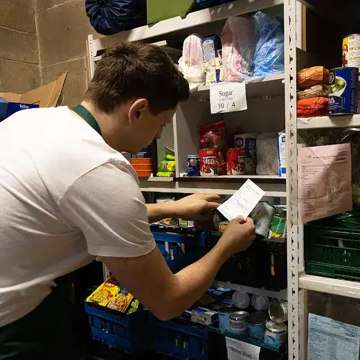 Volunteer scanning food items on shelves at Longridge Food Bank.